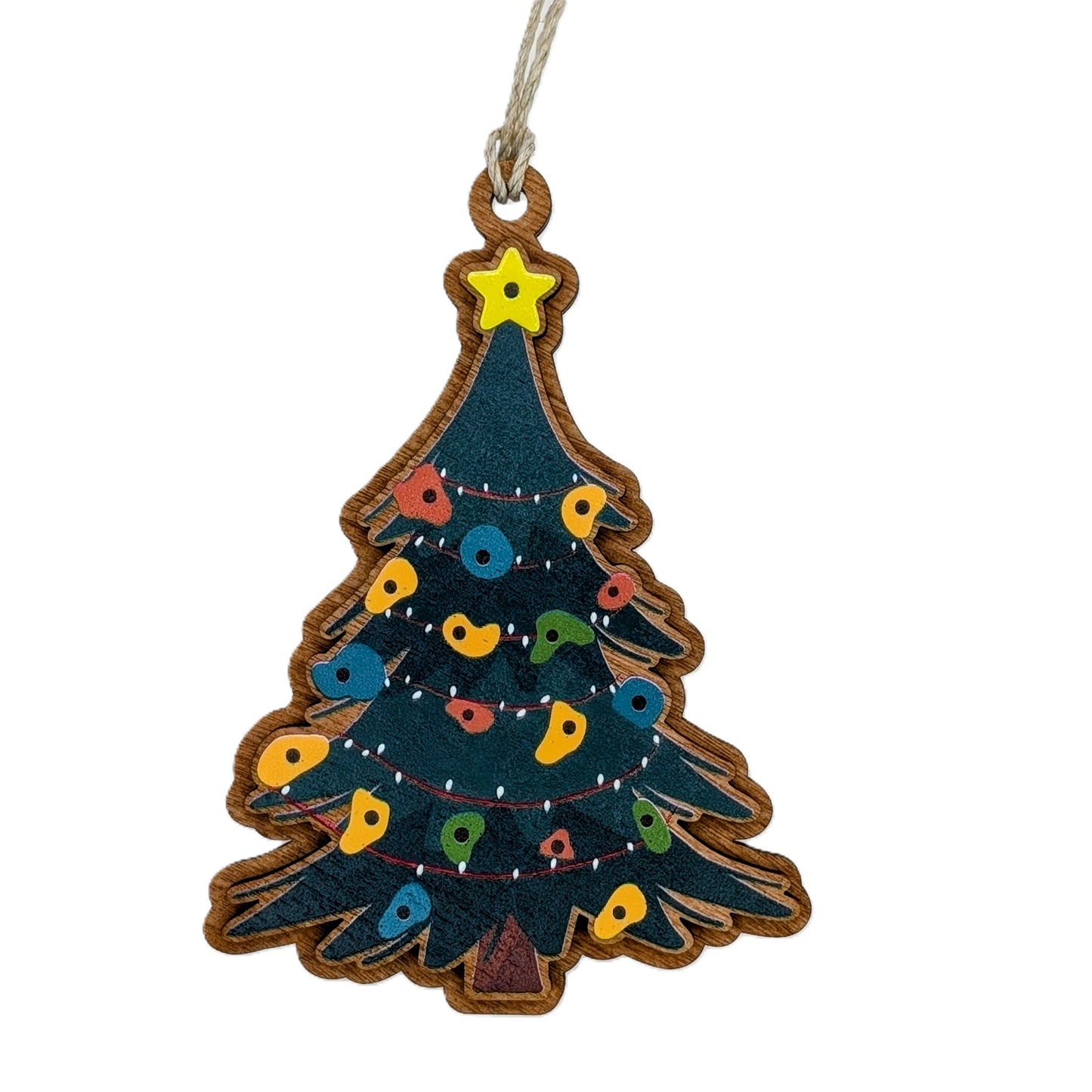 Decorative Christmas tree ornament with colorful rock climbing holds on a green pine branch background