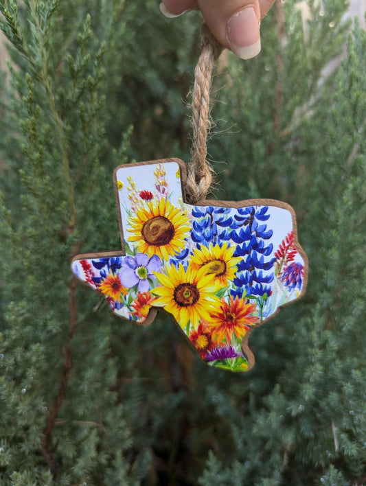 Texas Wildflower Christmas Ornament; bluebonnets, Indian paintbrushes, fire wheels, sunflowers, and coneflowers inside the state of Texas